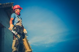 House Building Site and the Feeling Good Construction Worker. Contractor and His Homes Development Business. Right Side Copy Space